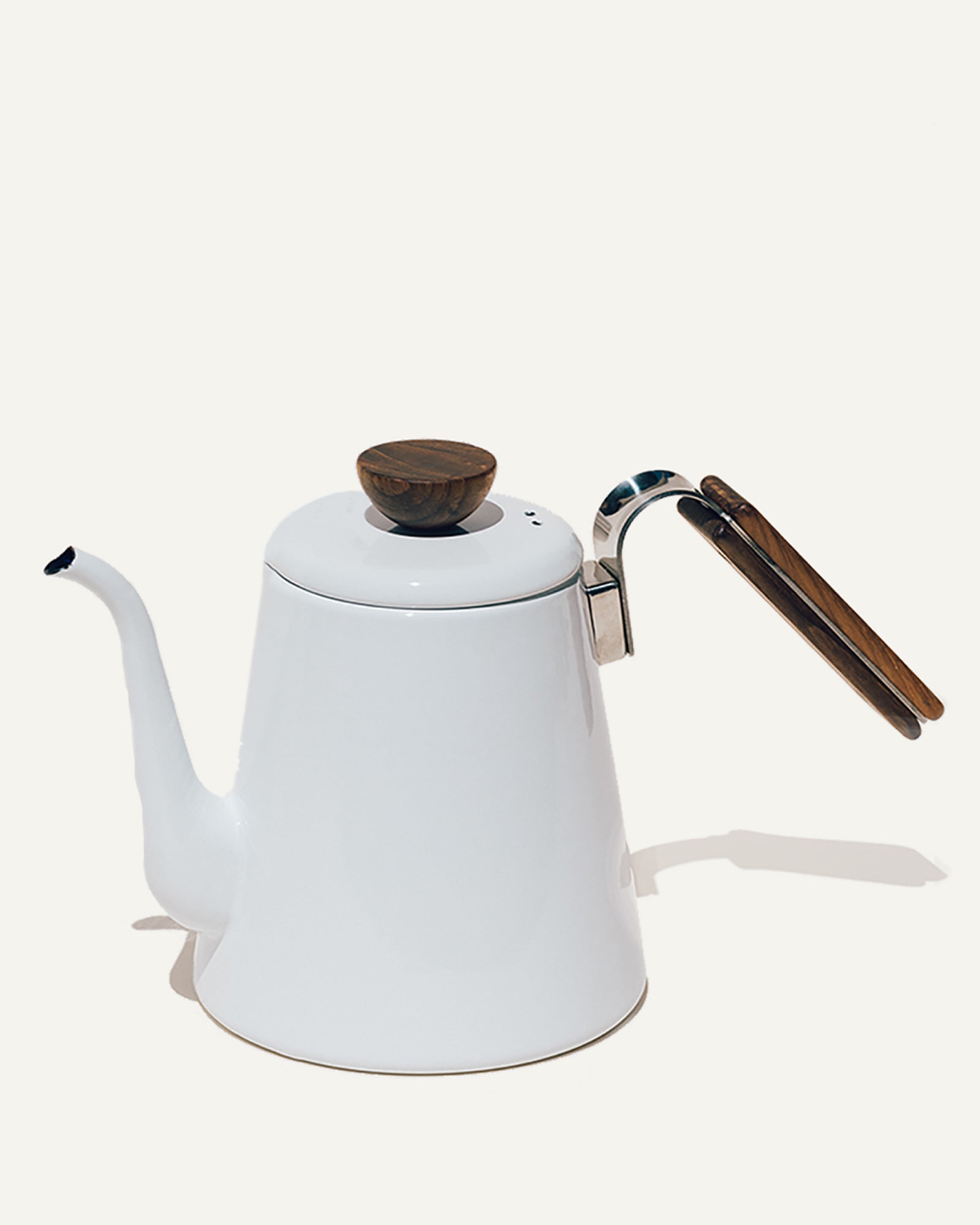A white enamel kettle by Bona with a wooden handle
