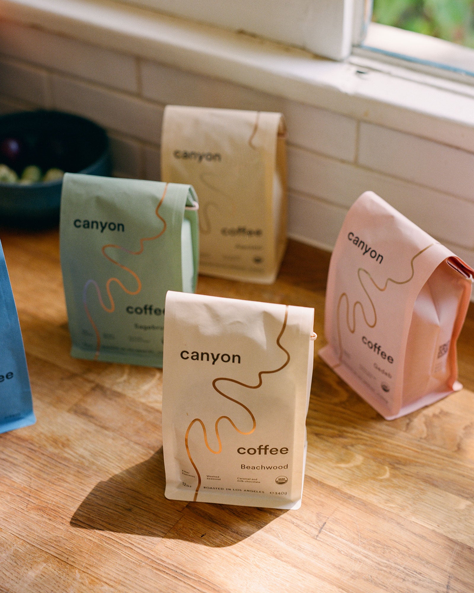 Bags of Canyon Coffee on a wood counter in Los Angeles