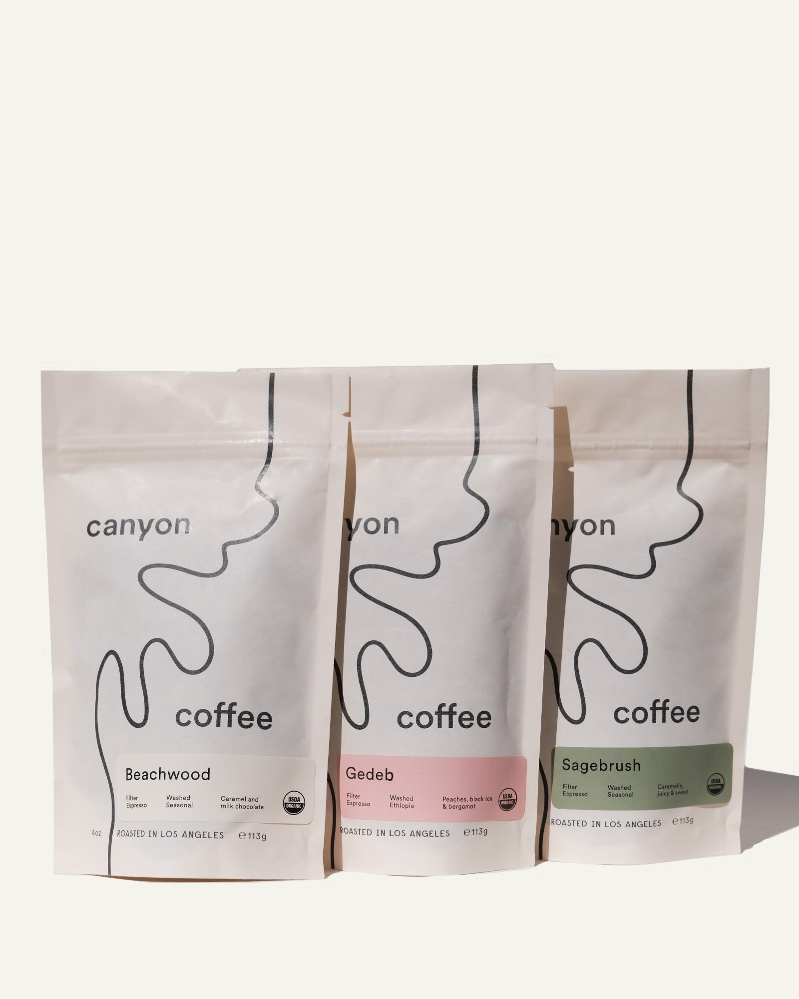 Three mini white bags of Coffee by Canyon Coffee Roasted in Los Angeles