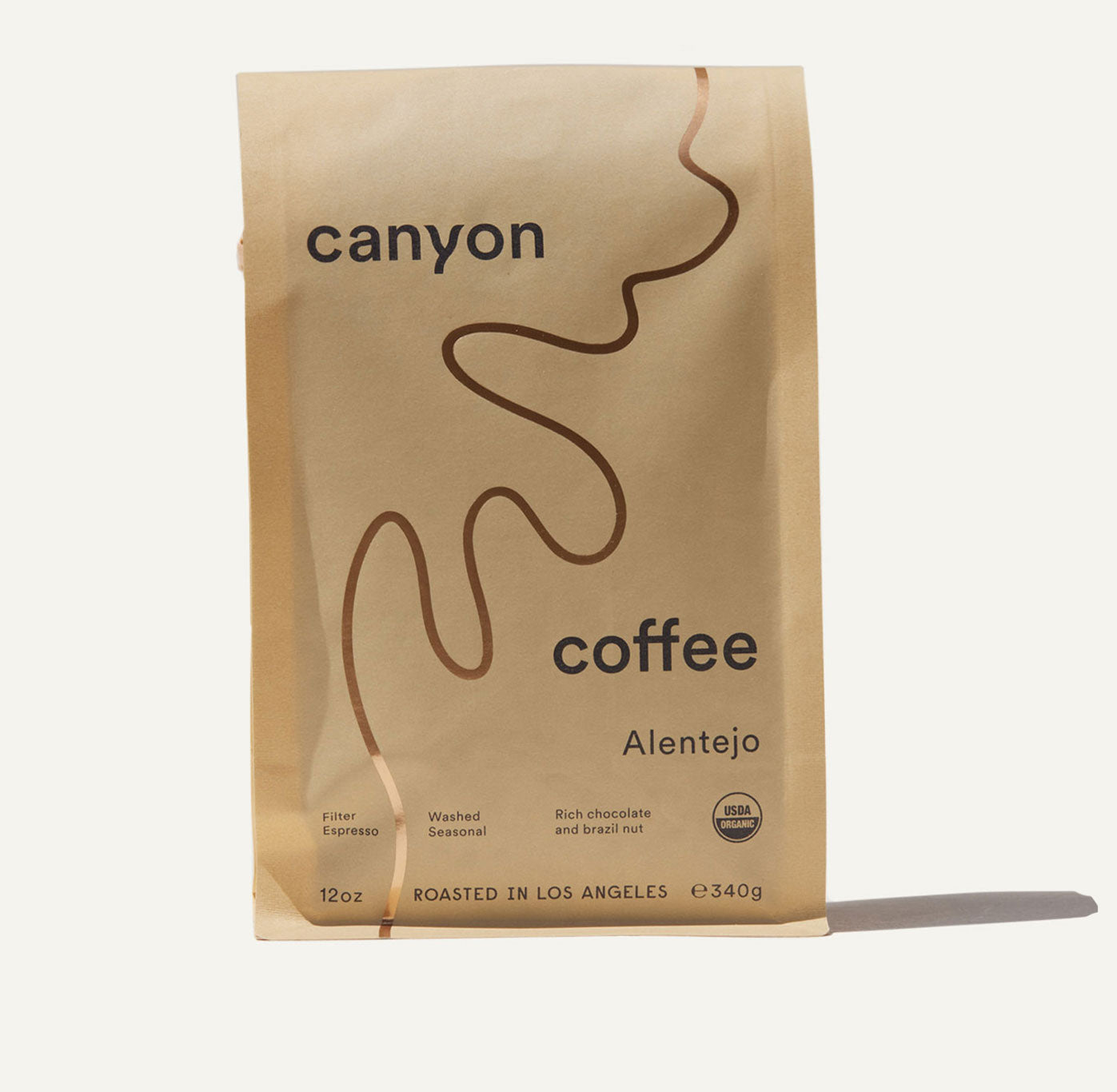 A yellow bag of Canyon Coffee with a gold foil river