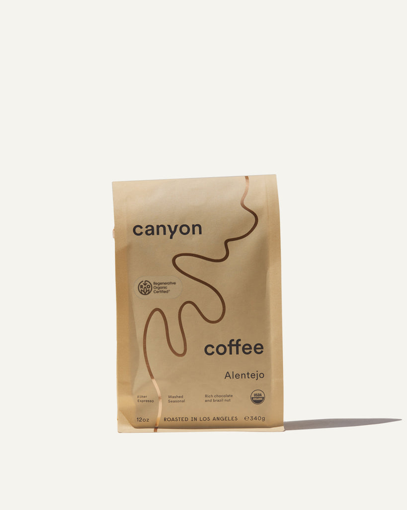 A bag of The Alentejo by Canyon Coffee packaging with gold foil. A Certified Regenerative Organic Coffee