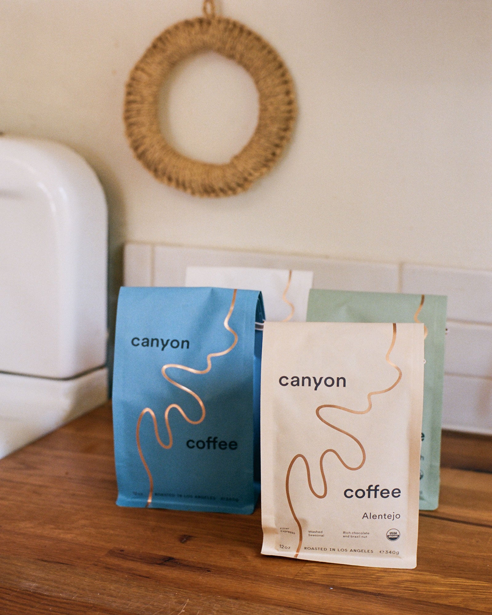 Bags of Canyon Coffee on a wood counter in Los Angeles
