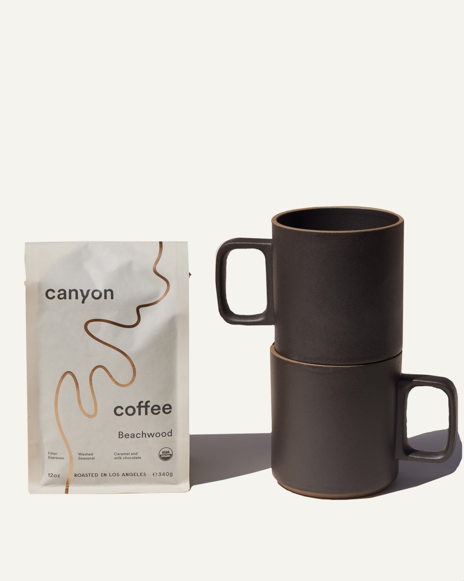 The Host Gift Bundle by Canyon coffee featuring a pair of tan Hasami mugs and a bag of organic coffee